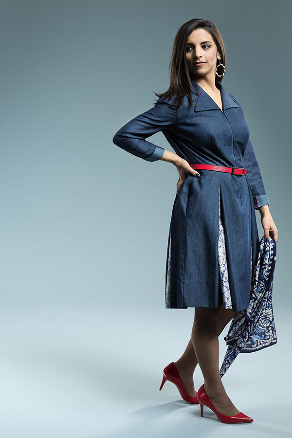 Women modeling multie-paneled blue dress with a red belt