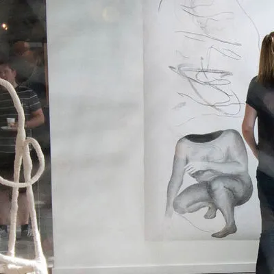 Artist checking artwork in gallery
