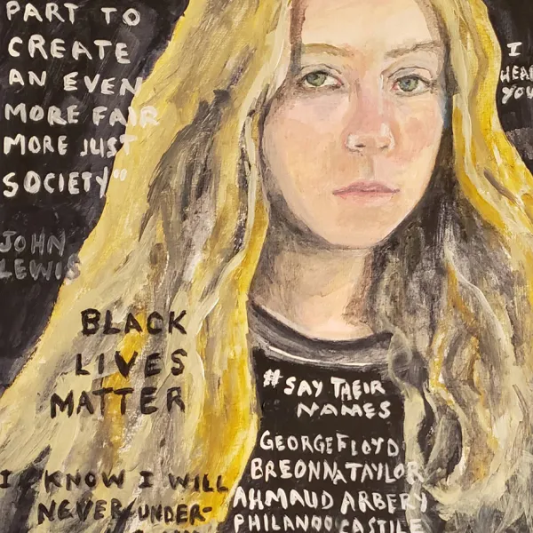 A white woman in a black T-shirt that says"#SAY THEIR NAMES" and lists George Floyd and others. On the side of the painting are a John Lewis quote, "BLACK LIVES MATTER", and a statement ending with "I STAND WITH YOU".