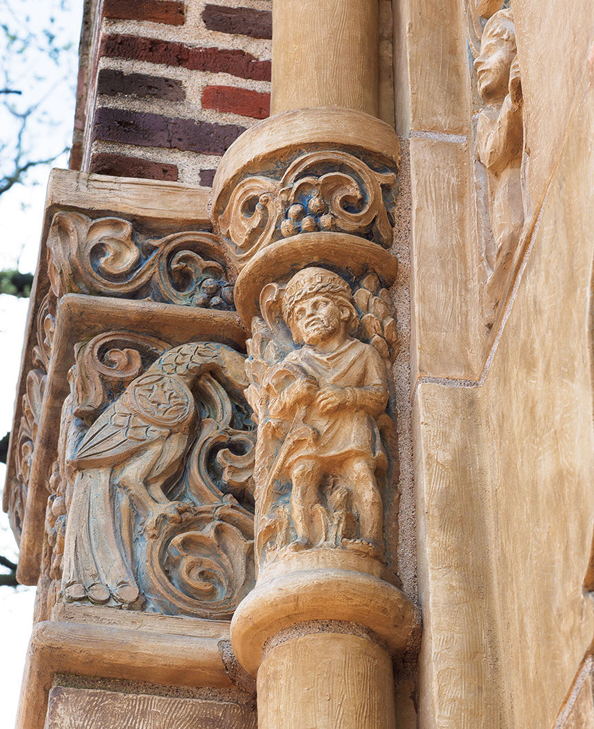 Detail of clay angel and bird integrated into the side of a chapel