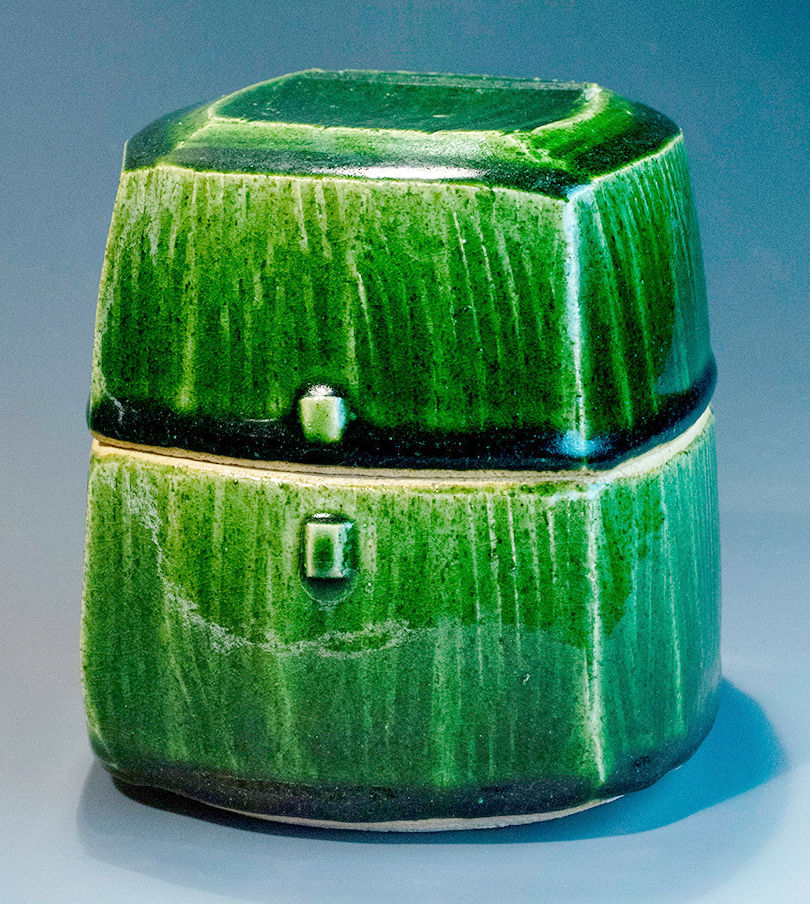 Squarish, dark green glazed jar with an equally squarish lid on top