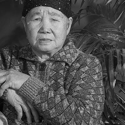 A black and white photo of a Hmong woman.