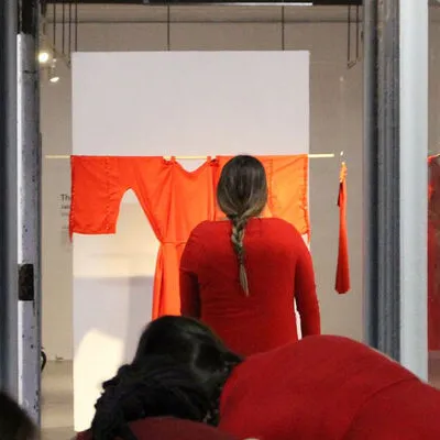 Red dress hung in gallery