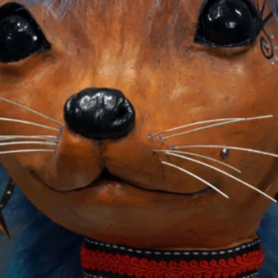 Close-up photo of a terra cotta figurine of an animal person dressed up in a goth punk style