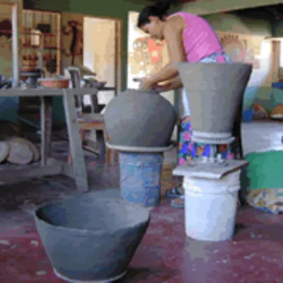 Woman working on ceramic pots