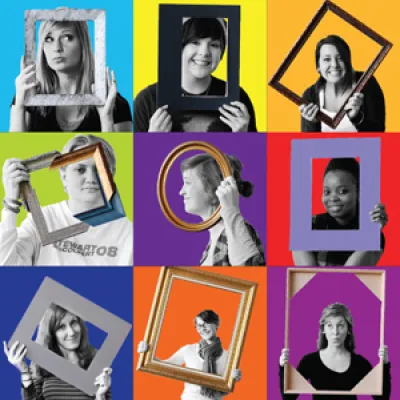 Students from art show holding up frames in front of their face with colorful backgrounds