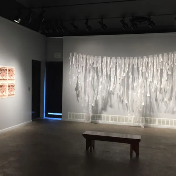 Overview of west gallery Art galelry displaying a bench and fabric