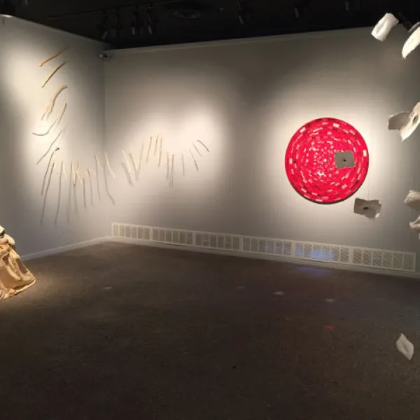 wide angle of art gallery showing red and white scultptures