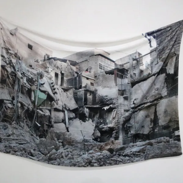 Receiving Blanket, 2016, plush blanket, image of bombed home in Aleppo, 32 x 42”.