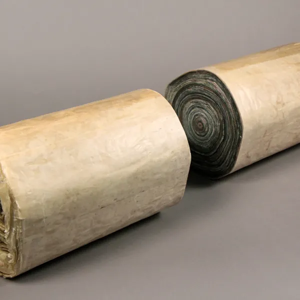 Yevgeniya Kaganovich, Paper Remembering Tree: log I, 2019, reused newspaper, wax 8 x 8 x 28” Two tightly-wrapped rolls of paper, resembling two pieces of a log.