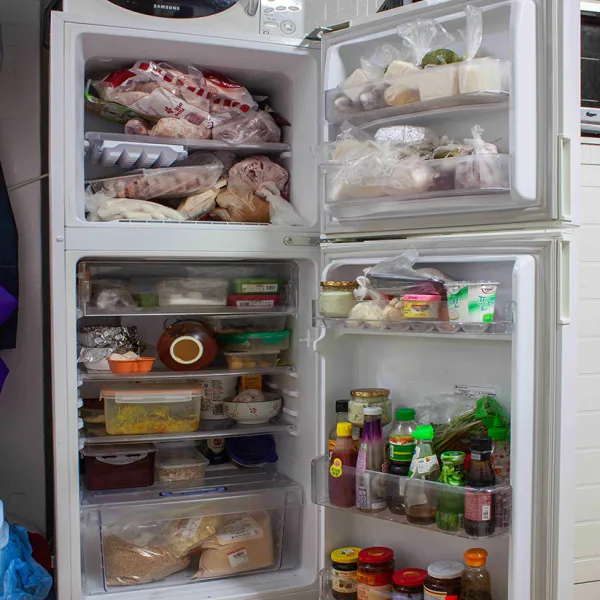 Melissa Kazua Vang, Eggs and Hotdog, 2014, inkjet on archival photo paper, 36 x 24” A refrigerator with the refrigerator and freezer doors open, displaying their contents.
