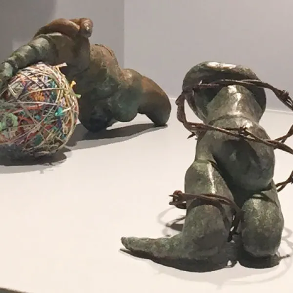 left: Able, 2018, bronze and fibers, 10 x 6 x 5"; right: Swaddled, 2017, bronze and barbed wire, 10 x 7 x 5"