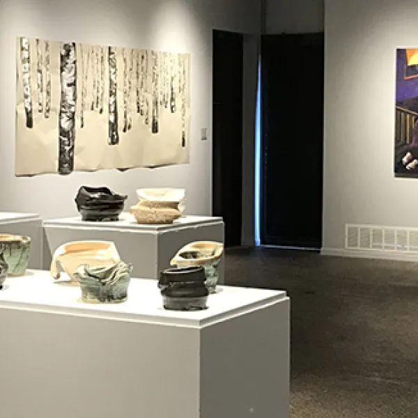 (foreground) Julia Nellessen, Practice Resurrection Series, porcelain, (back wall) Colleen Cosgrove, Moonhead (right), Place of Refuge (left), oil on canvas