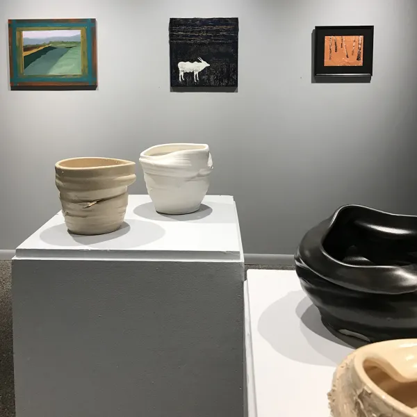 Julia Nellessen, Practice Resurrection Series, porcelain (foreground), (background left to right) Renee Santoro, I Dreamed of My Mother, oil on canvas, Chris Cinque, Neith & Moonlight, mixed media, Kathy Daniels, Orange Surprise, mixed media on rice paper