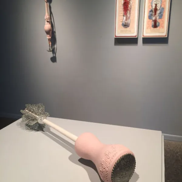 foreground: Colleen Toledano, Tangle Wand, 2005, ceramic, mixed media, 21 x 5 x 5"