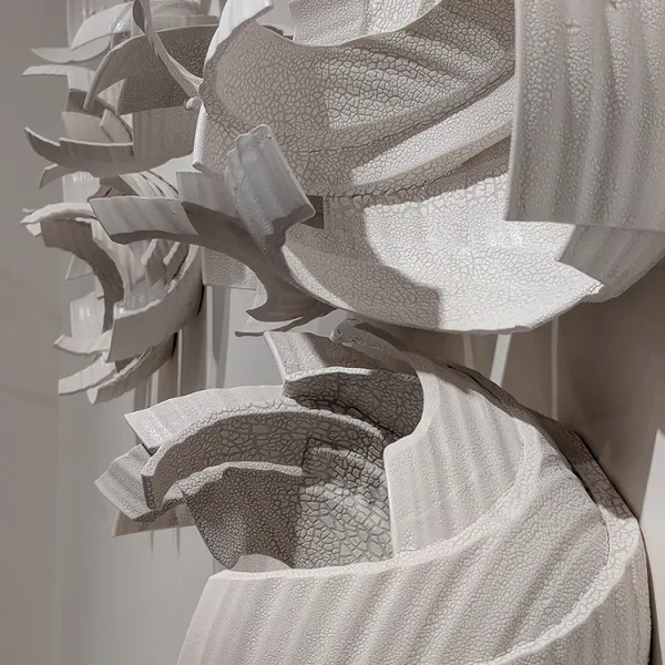 Monica Rudquist, Floating Wall Detail 2 Side view of abstract wall sculpture made of pieces of bowls.