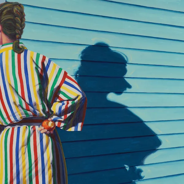 Woman with braided hair facing away from the viewer, wearing a robe with vertical red, blue, green, and yellow stripes, with one hand on her hip and holding something round (like an orange or apple).