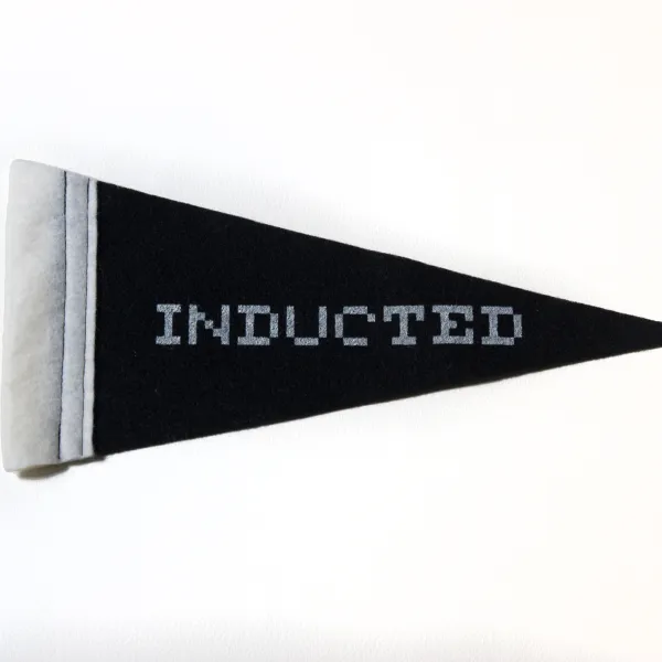 Inducted Mini Pennant, 2023, polyester, serigraph, 5.25" x 11" Black flag with "Inducted" written on it