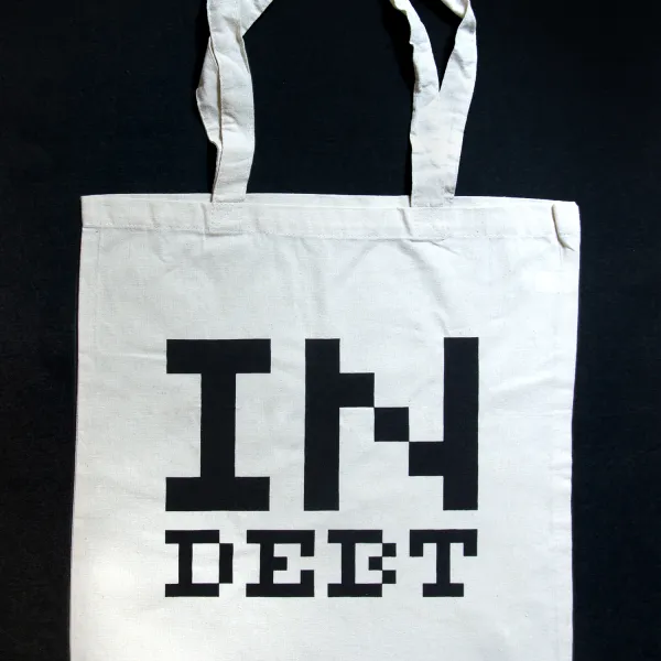 Inducted Swag Bag, 2023, canvas, serigraph, 24.5" x 14.75" White Swag Bag with "IN DEBT" written in black on it