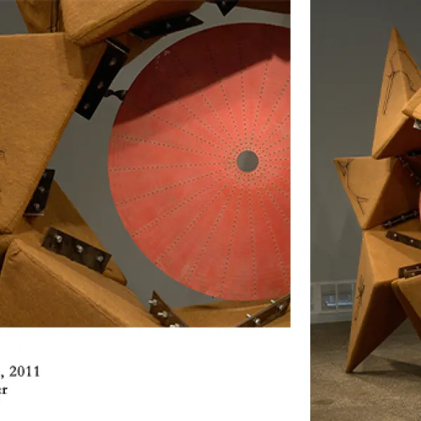 A large yellow and orange sculpture roughly depecting a jagged star, made of wood, felt, string, nails, and rubber.