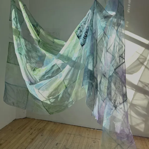 Sunlight passing through sheer blue and green fabric