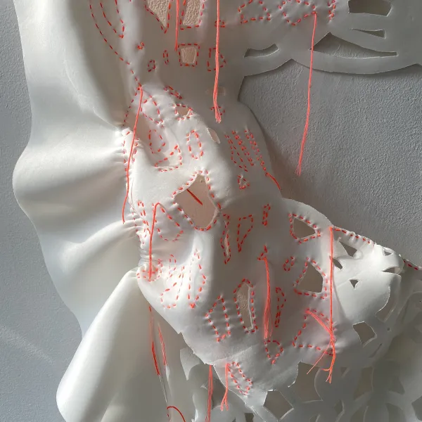 Florescent pink embroidery on soft, white fabric