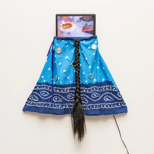 Soliloquy; Video installation with mirrored skirt, small video monitor, synthetic hair, video