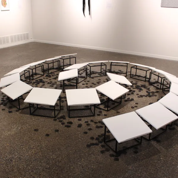 all Red Riding Hoods do not come out of the forest safe and whole, 2022; (sensitive subject matter) Site-specific floor installation: blind letterpress and collagraph print on paper, metal stands, and acrylic bases; Dimensions variable