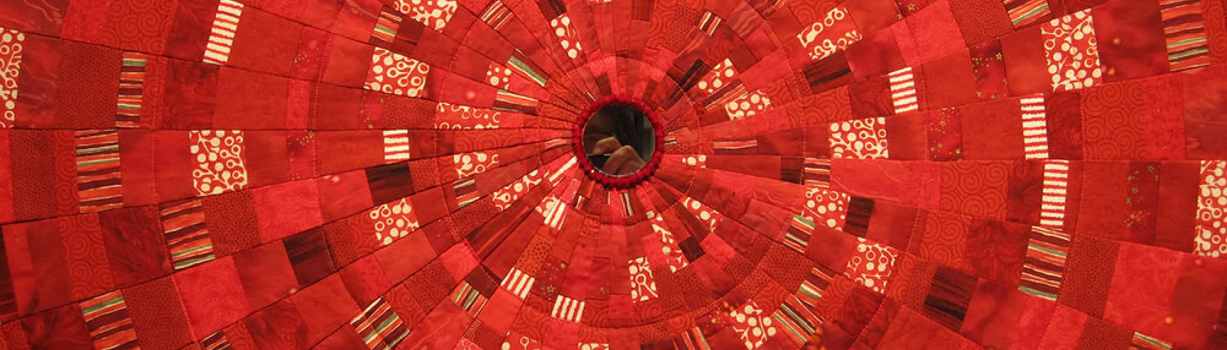 Closeup of red fabric with a circular pattern
