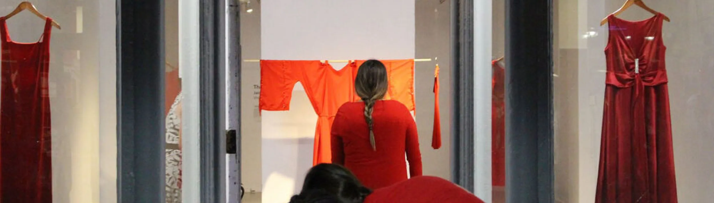 Red dress hung in gallery