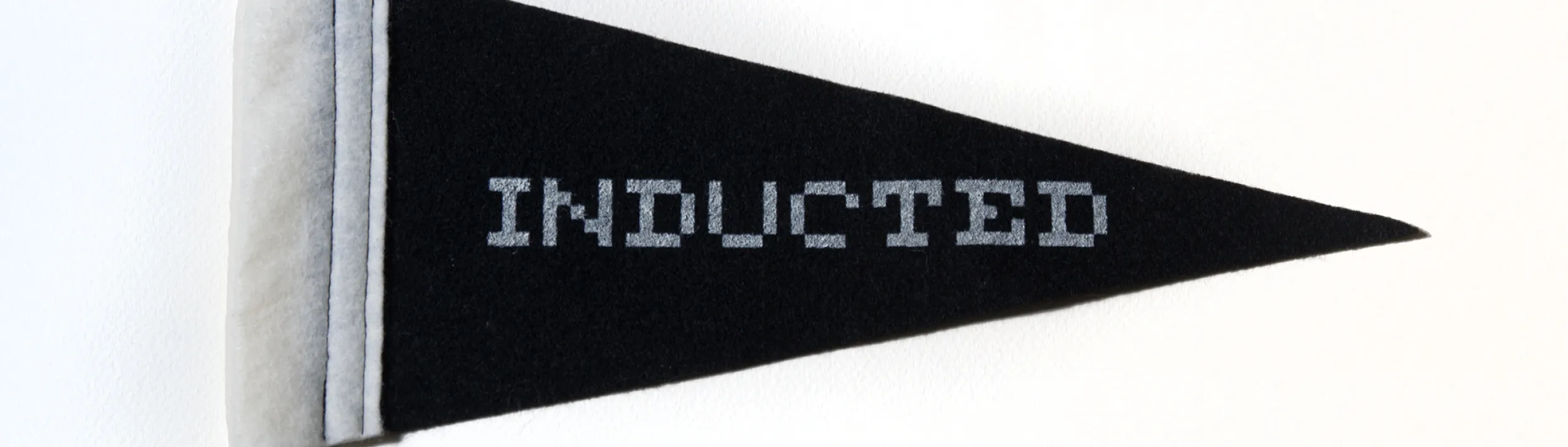 Black banner with the words Inducted on it.