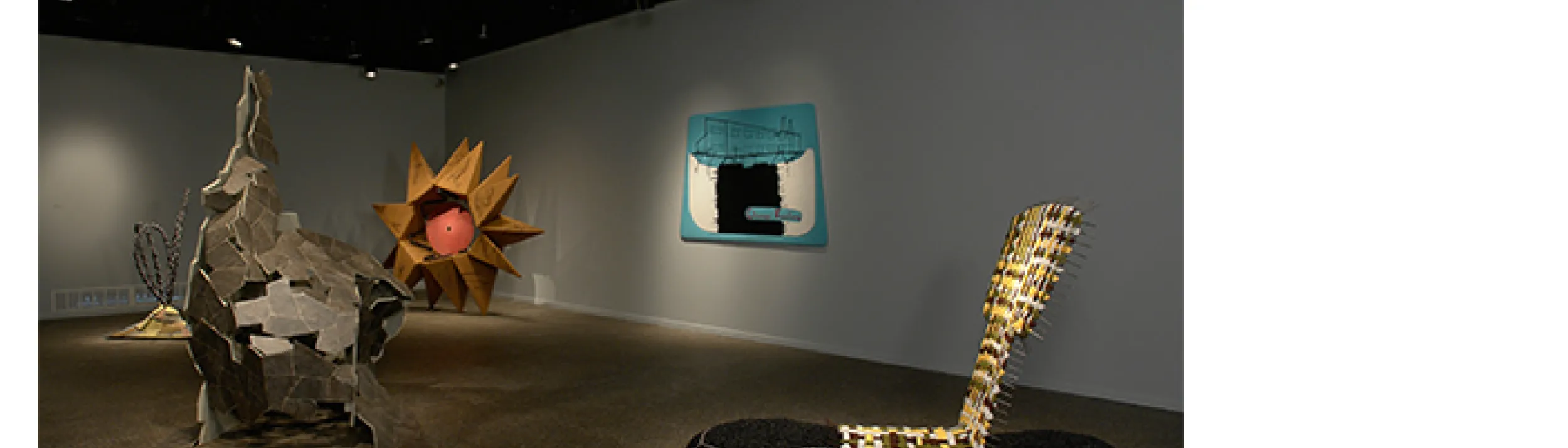 Wide shot of five different sculptures set up in the exhibition hall.