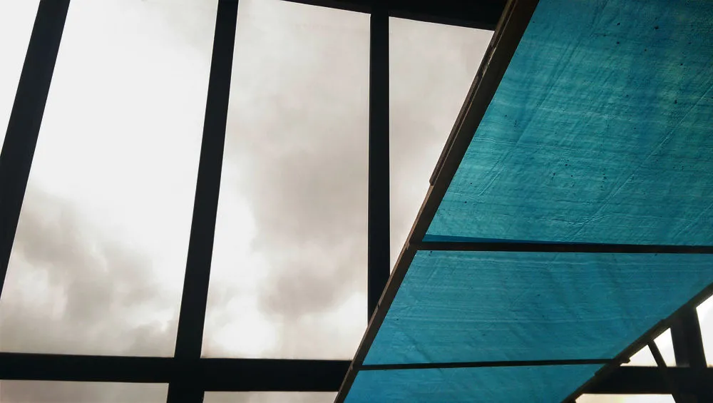 Windows looking at clouds, in black and white. Turquoise fabric panels on right side.